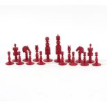 A red and white stained ivory chess set Condition Report: Red - Some staining,