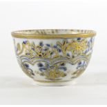 A Meissen blue and white tea bowl, circa 1775, highlighted in gilt,