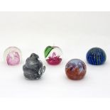 Five glass paperweights including three Caithness examples