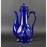 A Bohemian blue glass ewer and cover, circa 1870, each side cut with a star,