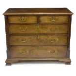 A George III mahogany chest of two short over three long drawers, flanked by fluted quarter columns,