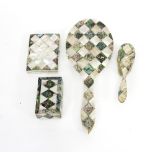 A mother-of-pearl and abalone backed hand mirror, a similar brush,