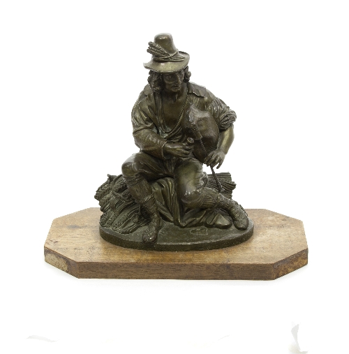 A bronze figure of an Irish piper, seated on a sheaf of corn and mounted on a board, 28.