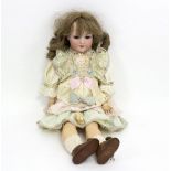 An Armand Marseille bisque head doll in a tiered silk dress, with jointed composition body,