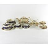 A Derby part tea set, circa 1815, comprising teapot and stand, milk jug, two tea cups,