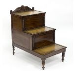 A George IV step commode of three steps with tooled leather inset,