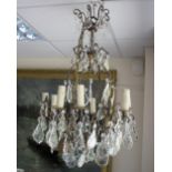 A twelve-branch eight-light chandelier hung with glass drops,