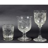 A group of three drinking glasses with engraved initials comprising 'EH' and vines,