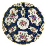 A Worcester porcelain plate, circa 1760, with scalloped edge, dark blue ground,