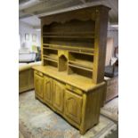 An oak dresser with open rack above drawers and cupboards, 192.