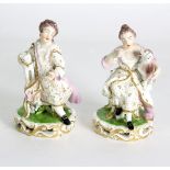 A pair of Derby seated figures with a cat and dog, circa 1830,