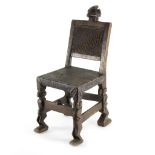 A Chokwe Angolan chair, the carved wooden frame with head to crest rail and figural legs,