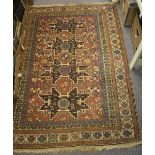 A Hamadan rug with four star shaped medallions to a red ground geometric field,