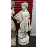 A reconstituted stone garden statue of a girl with basket of fruit,