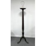 A mahogany torchère with reeded column on a tripod base,