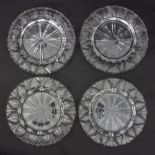 A set of four clear glass plates, deeply cut with radiating lines and arches to the border, 22.