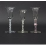 Three Continental opaque twist stem wine glasses circa 1750, with trumpet bowls,
