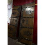 A pair of Chinese wooden doors with metal strap work decoration,