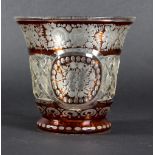 A Bohemian ruby stained cut glass vase decorated with flowers,