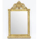 A gilt framed wall mirror with pierced scroll pediment and floral moulding,