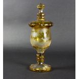 A Bohemian amber stained glass goblet and cover, engraved running deer in a landscape,
