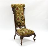 A Victorian walnut framed prie-dieu chair with needlework upholstery,