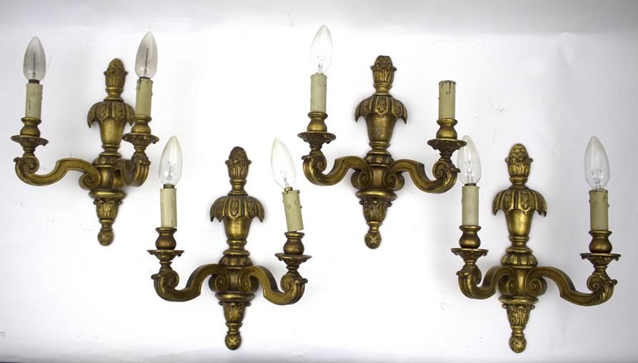 A set of four gilded wall lights