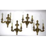 A set of four gilded wall lights