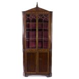 A George III mahogany and inlaid floor standing corner cupboard,