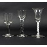 Three English wine glasses, circa 1750, one with opaque twist stem, one with facet stem,