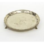 A George III silver waiter, WC, London 1775, on three scroll feet, 20.