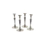 A set of four George III silver candlesticks, John Schofield, London 1783, with beaded borders, 28.