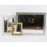 A modern wall mirror, the bevelled glass,