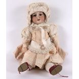 An Armand Marseille bisque head doll with sleepy eyes, open mouth with teeth,