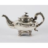 A Victorian silver teapot, E S, London 1840, with flower finial and of compressed lobed form,