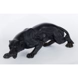 A carved model of a panther, carved from volcanic rock,