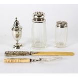 A butter knife with silver blade and carved ivory handle, a silver pepper pot,