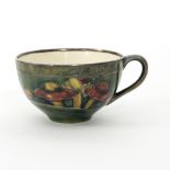 A Moorcroft Claremont teacup with silver overlay for Shreve & Co.