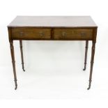 A George IV mahogany table fitted two drawers, on turned legs,