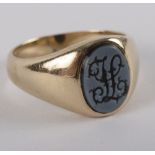 A precious yellow metal mounted signet ring set with an oval carved intaglio, monogrammed 'H',