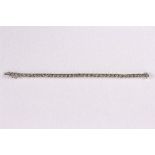 A diamond tennis bracelet with 36 collet set diamonds in 18ct white gold,