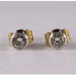 A pair of diamond stud earrings, each approximately 0.