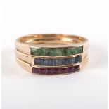 An 18ct gold ruby, emerald and sapphire stacking ring, each band set a row of channel set stones,