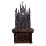 A 19th Century carved Italian cabinet modelled as Siena Cathedral, with clock to the top centre,