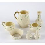 A group of Belleek shamrock porcelain comprising a basket weave jug, milk jug and sugar bowl,