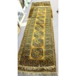 Three Afghan rugs worked in black to a golden ground,