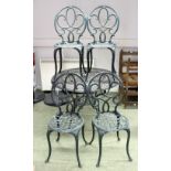 A cast iron garden table and four chairs