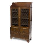 A mahogany side cabinet, the upper section enclosed by grille panel doors,