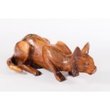 A model of a crouching cat, carved in yew wood,