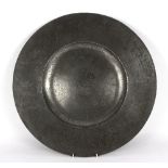 A broad rimmed pewter charger, by RC, naively engraved with signs of the zodiac, 45.